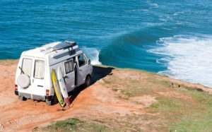 Campervan in front of the surf spot with nice wave at Atlantic Coast