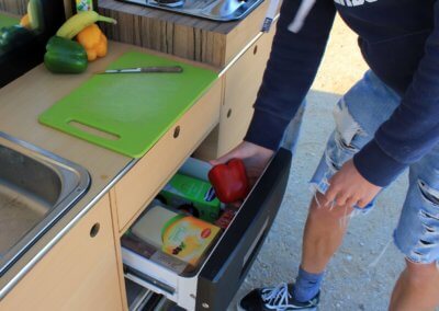 Lunch preparation inside campervan in surf holidays