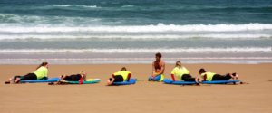 surf lessons atlantic coast, surfer girls and surf teacher on the surf lesson, atlantic coast, uncrowded beach, sunshine, ocean