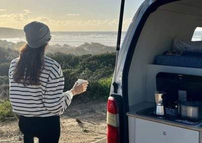 Enjoying a scenic sunset view from an Atlantic Coast Campers Bacalhau campervan in Portugal